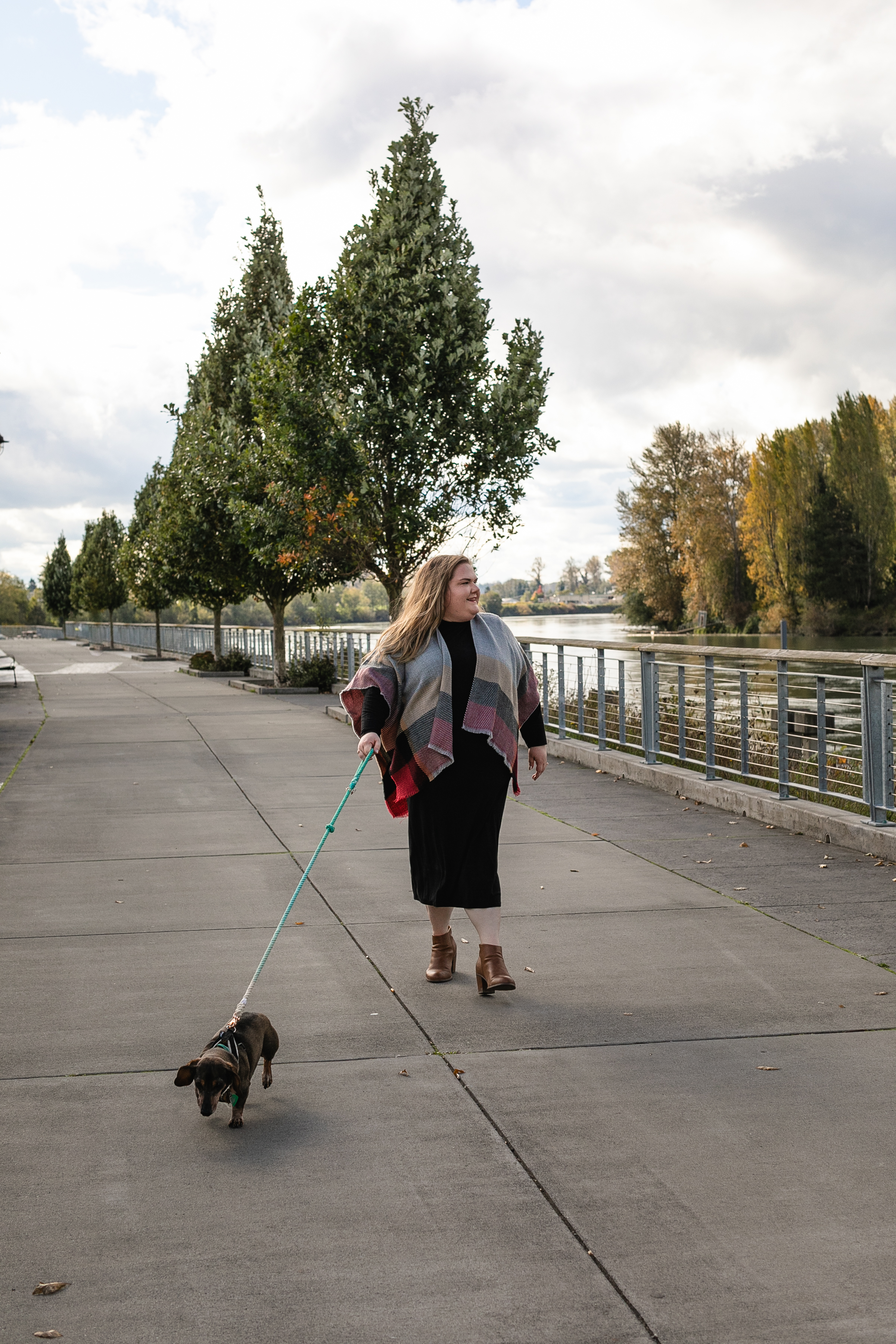 Career Coach, Jessica, walking dachshund along the river. 