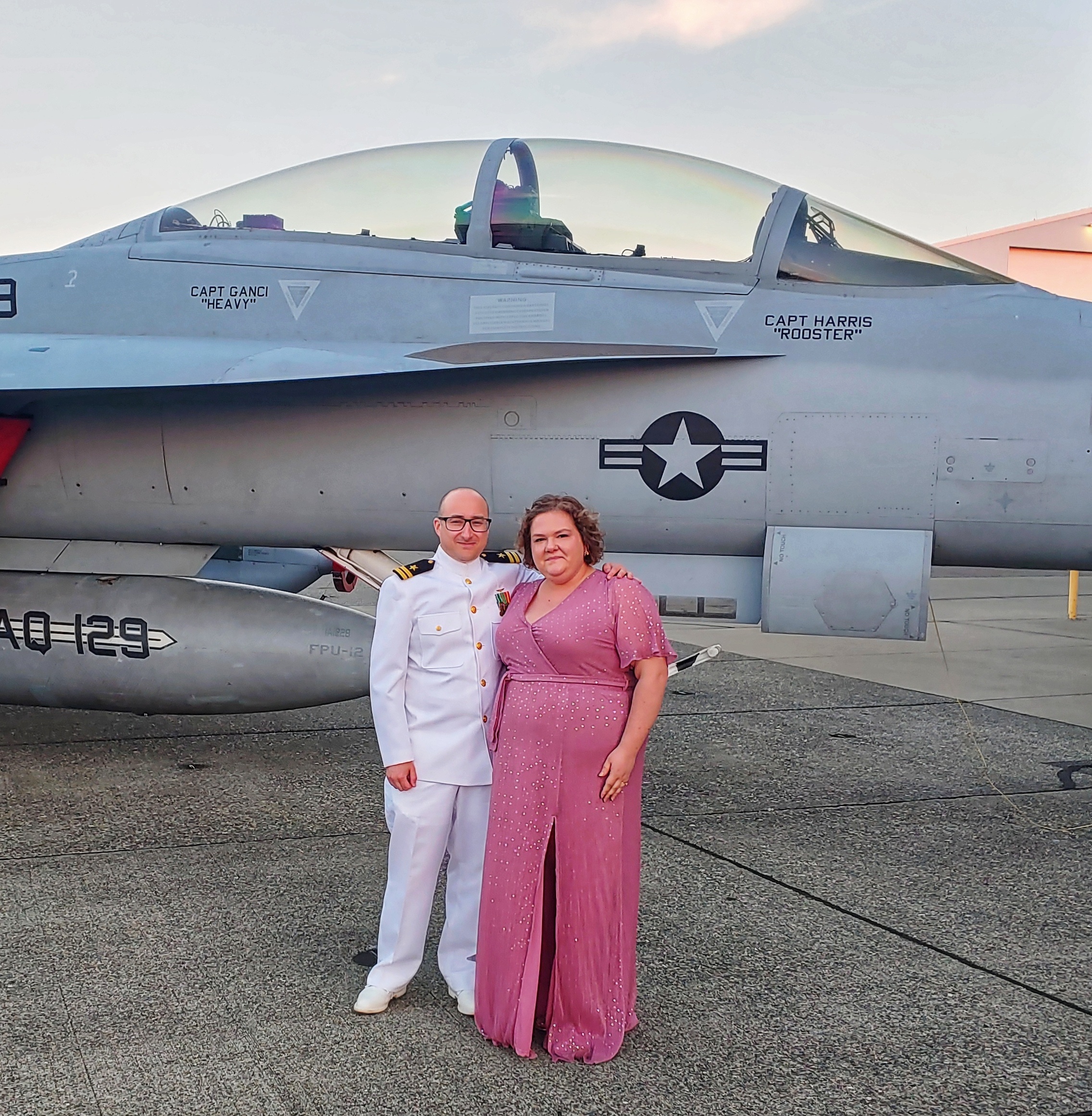 Jessica and husband in front of fighter jet