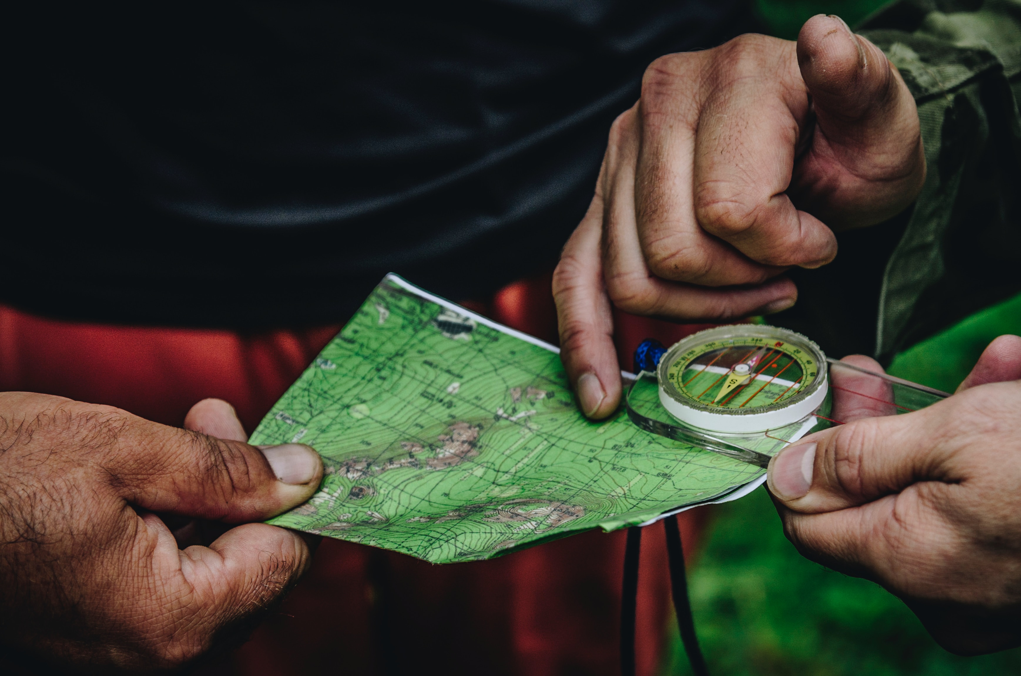 two people looking at a map with compass